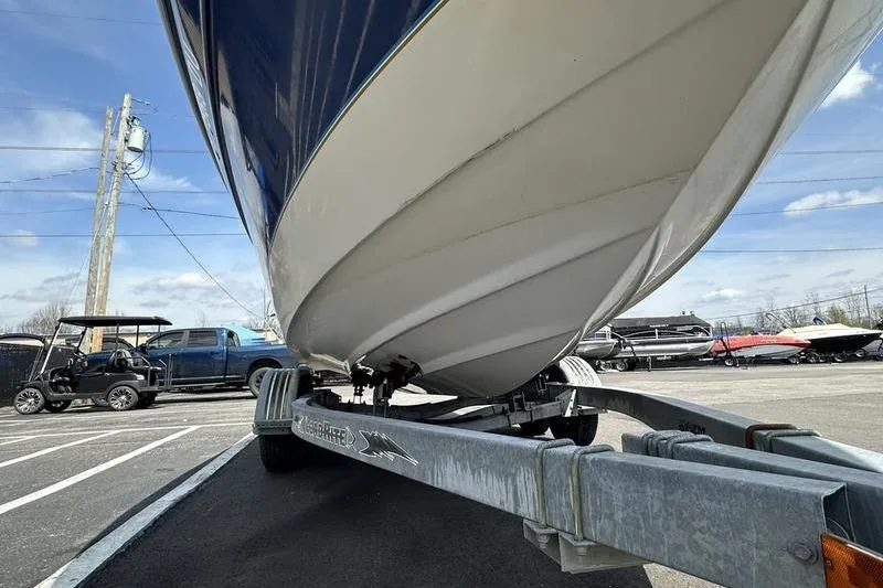 Slide: The Image of 1994 Sea Ray 220 Overnighter Signature boat on trailer, parked outdoors. - 13