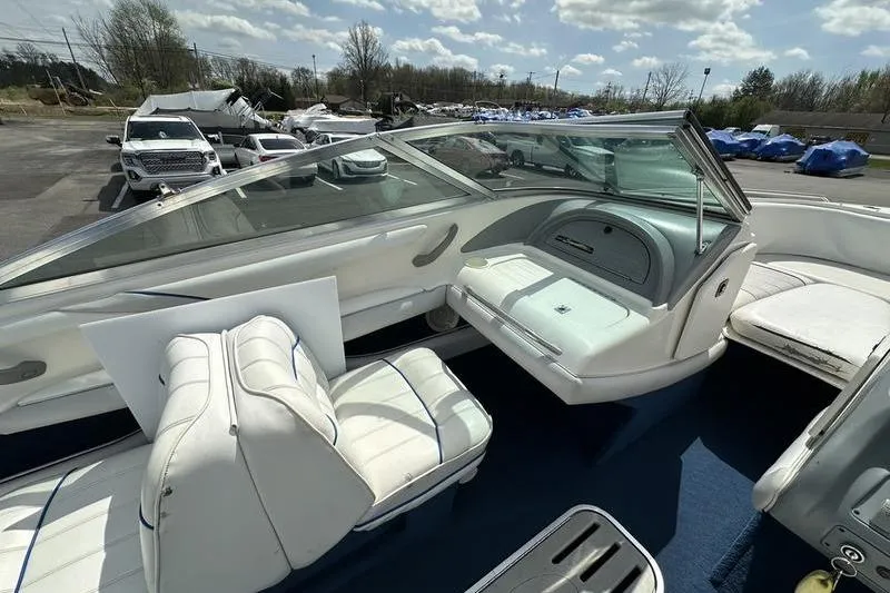 Slide: The Image of 1994 Sea Ray 220 Overnighter Signature boat interior with white seating and dashboard. - 14