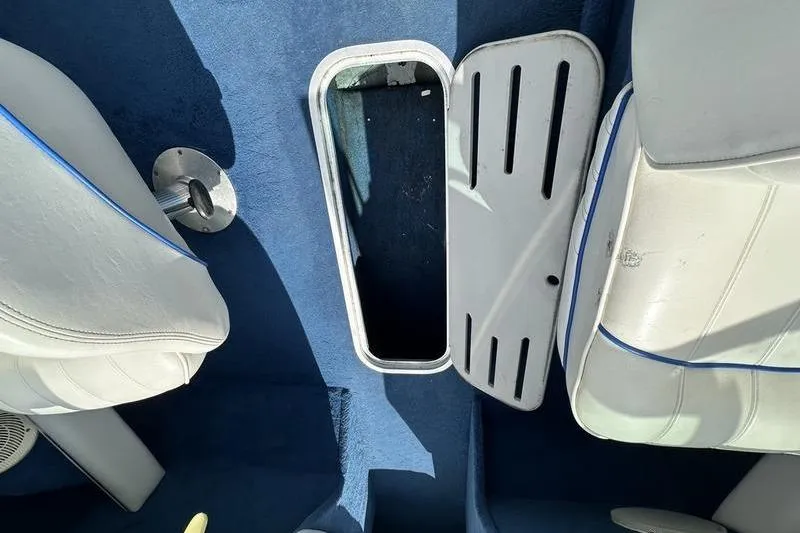 Slide: The Image of Interior of 1994 Sea Ray 220 Overnighter Signature with open storage compartment. - 15