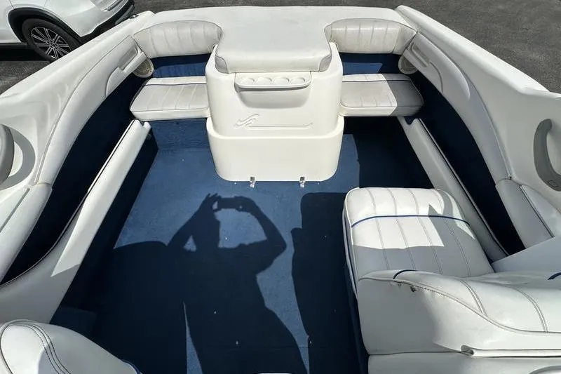 Slide: The Image of Interior of a 1994 Sea Ray 220 Overnighter Signature boat with white seating and blue carpet. - 17