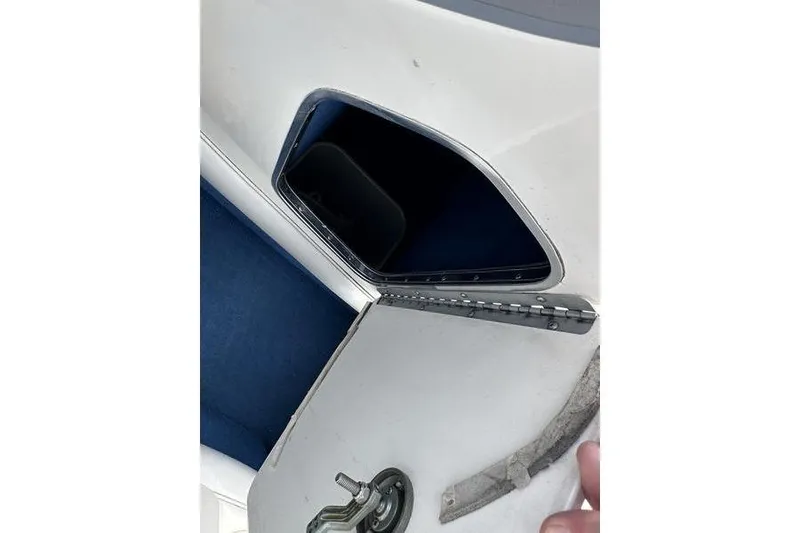 Slide: The Image of 1994 Sea Ray 220 Overnighter Signature boat compartment with open hatch and blue interior. - 20