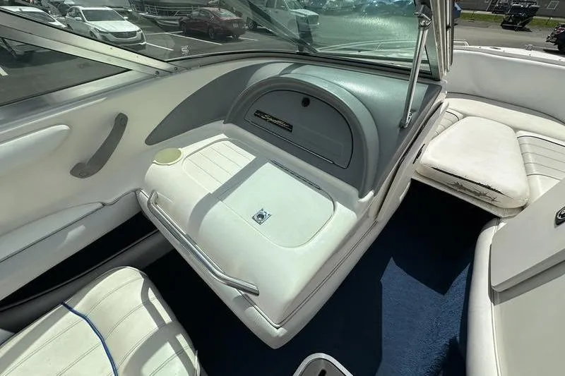 Slide: The Image of 1994 Sea Ray 220 Overnighter Signature boat interior with white seating and dashboard. - 22