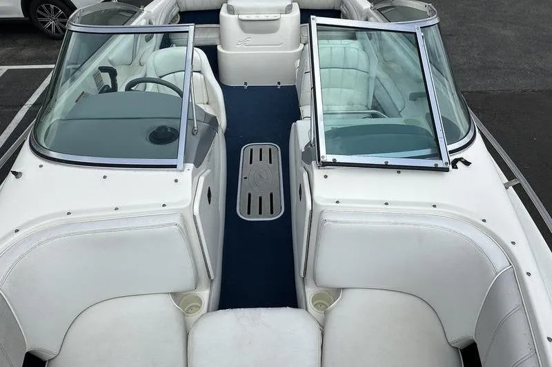 Slide: The Image of 1994 Sea Ray 220 Overnighter Signature boat interior with white seating and blue carpet. - 23