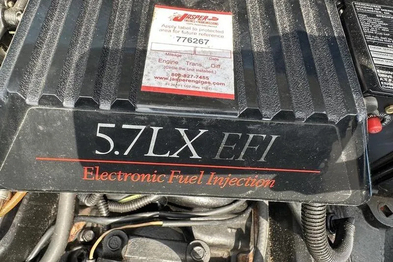 Slide: The Image of Engine cover of a 1994 Sea Ray 220 Overnighter Signature with 5.7LX EFI label. - 28