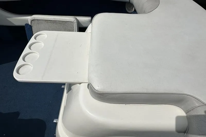 Slide: The Image of 1994 Sea Ray 220 Overnighter Signature boat seat with integrated cup holders. - 29