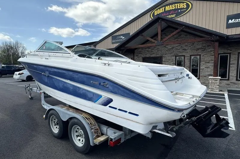 Slide: The Image of 1994 Sea Ray 220 Overnighter Signature boat on trailer outside dealership. - 4