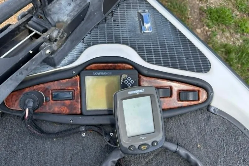 Slide: The Image of 2001 Triton Tr-21 Executive DC dashboard with Lowrance and Humminbird fish finders. - 11