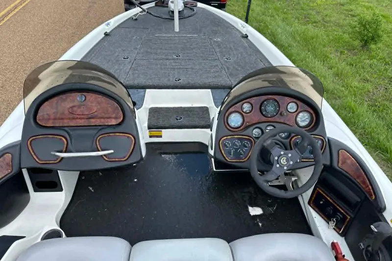 Slide: The Image of 2001 Triton Tr-21 Executive DC boat dashboard with steering wheel and instrument panel. - 12