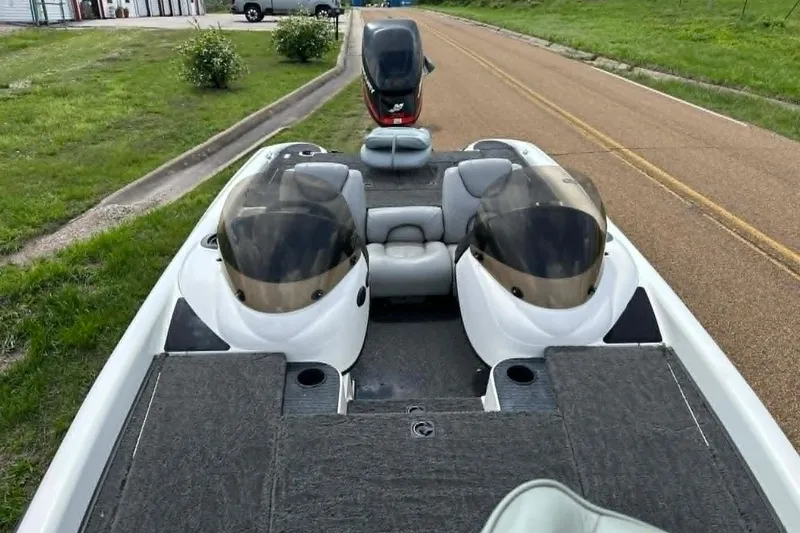 Slide: The Image of 2001 Triton Tr-21 Executive DC boat with dual consoles on a road. - 13
