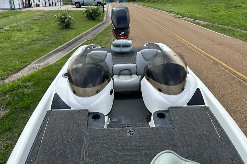 Slide: The Image of 2001 Triton Tr-21 Executive DC boat on a road, featuring dual consoles and seating. - 4