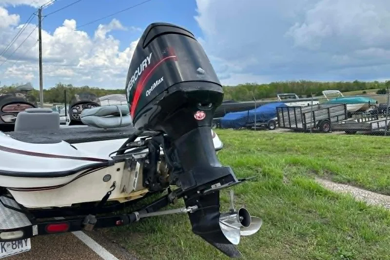 Slide: The Image of 2001 Triton Tr-21 Executive DC boat with Mercury Optimax engine on a grassy lot. - 5