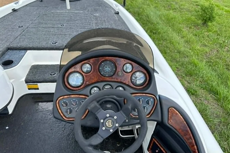 Slide: The Image of 2001 Triton Tr-21 Executive DC boat dashboard with steering wheel and gauges. - 6