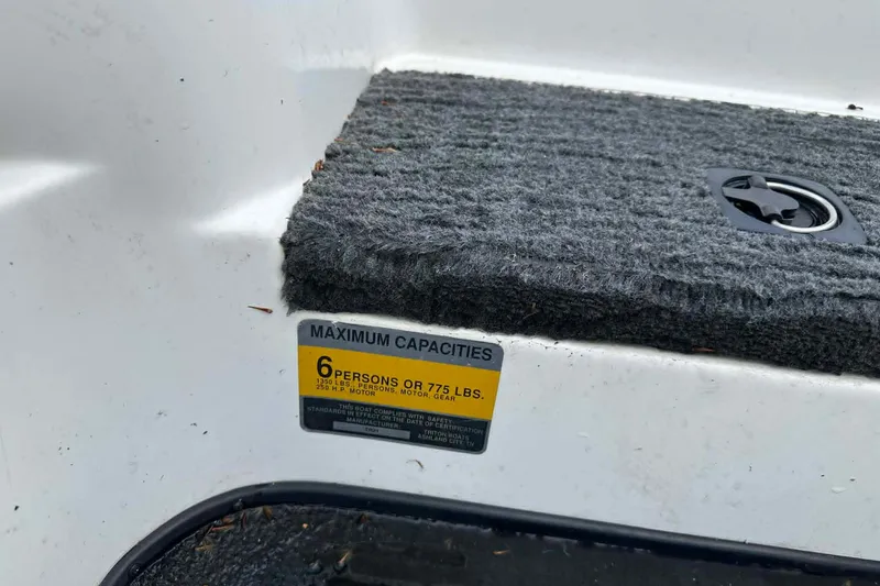 Slide: The Image of 2001 Triton Tr-21 Executive DC boat capacity label, indicating a maximum of 6 persons or 775 lbs. - 7