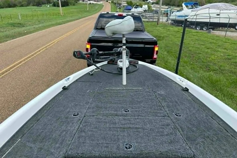 Slide: The Image of 2001 Triton Tr-21 Executive DC boat on trailer, parked on rural road. - 8