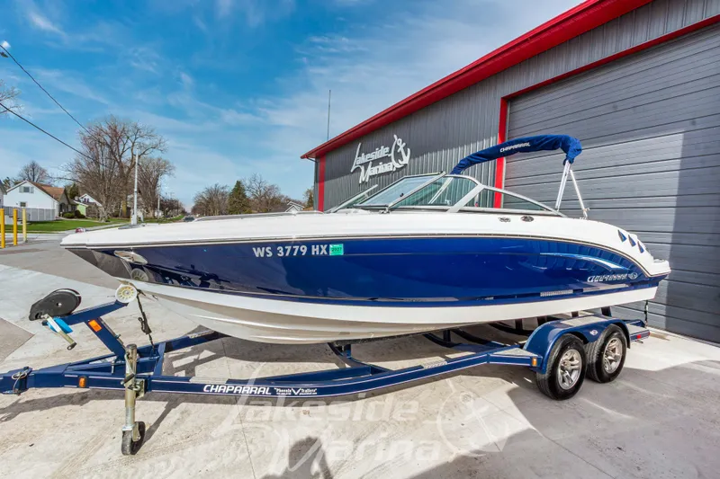 The Image of 2012 Chaparral 226 SSi boat on trailer at Lakeside Marina, blue and white design. - 1
