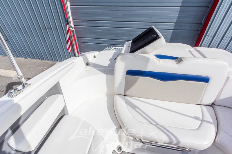 Slide: The Image of 2012 Chaparral 226 SSi boat interior with white seating and blue accents. - 18