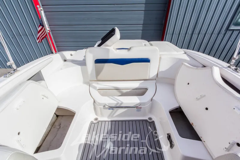 Slide: The Image of 2012 Chaparral 226 SSi boat interior with seating and storage compartments. - 19