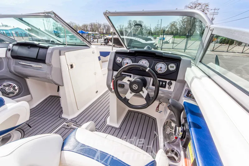 Slide: The Image of Interior view of 2012 Chaparral 226 SSi boat, featuring steering wheel and dashboard controls. - 23