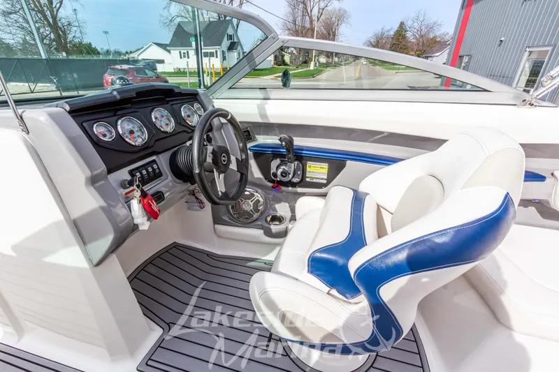Slide: The Image of 2012 Chaparral 226 SSi boat interior with steering wheel and gauges. - 24