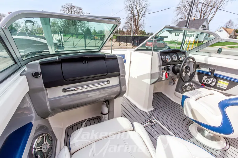 Slide: The Image of Interior view of a 2012 Chaparral 226 SSi boat, featuring sleek dashboard and seating. - 28