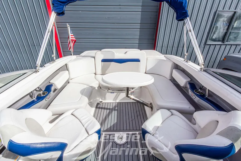 Slide: The Image of 2012 Chaparral 226 SSi boat interior with white seating and round table. - 30