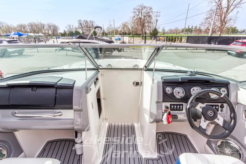 Slide: The Image of Interior view of 2012 Chaparral 226 SSi boat cockpit with steering wheel and dashboard controls. - 31