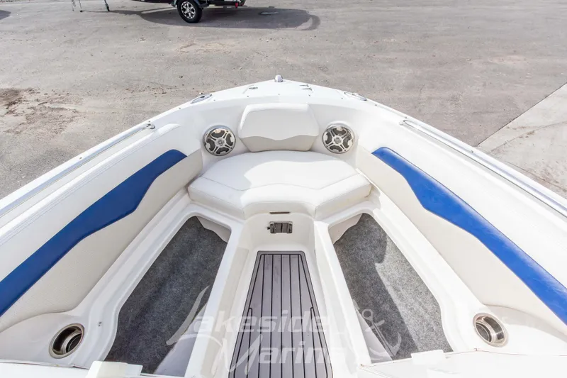 Slide: The Image of 2012 Chaparral 226 SSi boat interior with white and blue seating, speaker, and carpeted floor. - 36