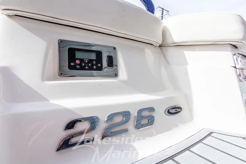 Slide: The Image of 2012 Chaparral 226 SSi boat interior with control panel and model emblem. - 8