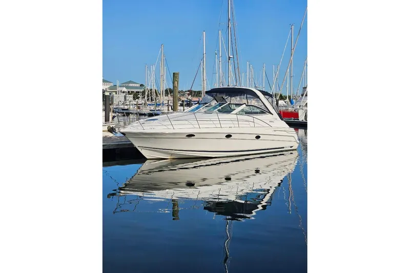 The Image of 1999 Doral 360 SE yacht docked in a marina, reflecting on calm water. - 0