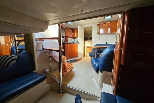 Slide: The Image of Interior of a 1999 Doral 360se yacht with luxurious seating and wooden cabinetry. - 14