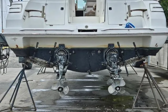 Slide: The Image of 1999 Doral 360se boat on stands, showing dual propellers and stern details. - 16
