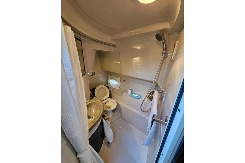 Slide: The Image of 1999 Doral 360se boat bathroom with shower, sink, and toilet. - 8