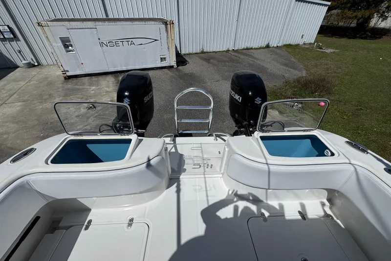 Slide: The Image of 2023 Insetta 35 IFC boat with Suzuki engines and open storage compartments. - 13