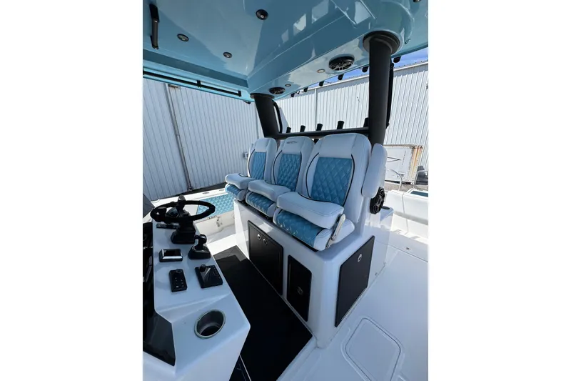 Slide: The Image of 2023 Insetta 35 IFC boat interior with blue cushioned seating and modern controls. - 7