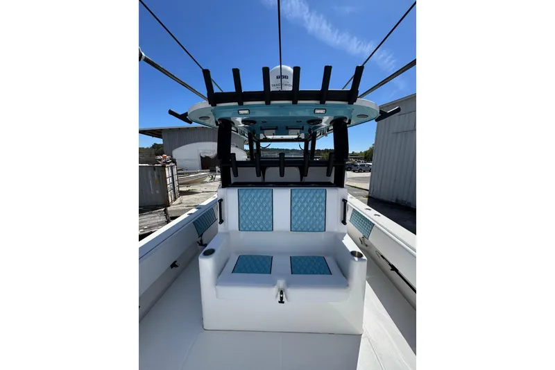 Slide: The Image of 2023 Insetta 35 IFC boat interior with blue seating and overhead rod holders. - 8