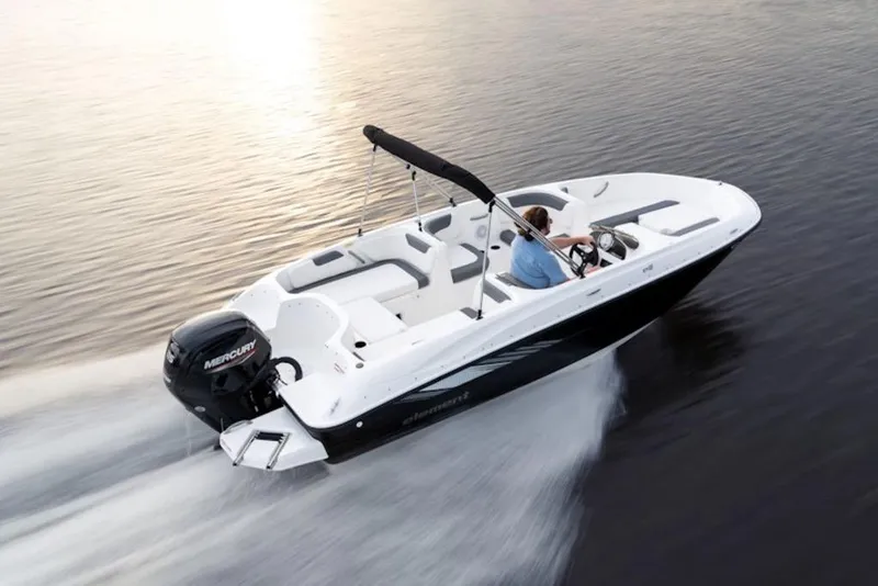 Slide: The Image of 2026 Bayliner Element E18 boat cruising on calm water at sunset. - 5