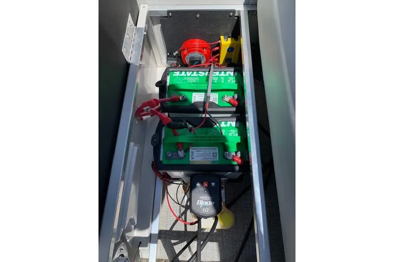 Slide: The Image of Battery compartment of 2025 Avalon 2585 Venture QL High Performance Tri-Toon boat. - 12