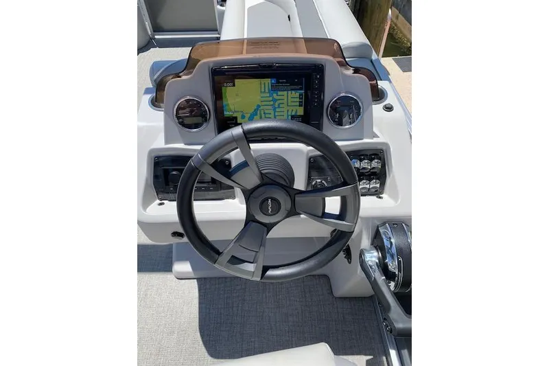 Slide: The Image of Steering console of 2025 Avalon 2585 Venture QL Tri-Toon with navigation display. - 3