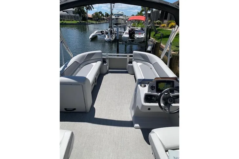 Slide: The Image of 2025 Avalon 2585 Venture QL Tri-Toon boat interior with sleek seating and modern controls. - 4