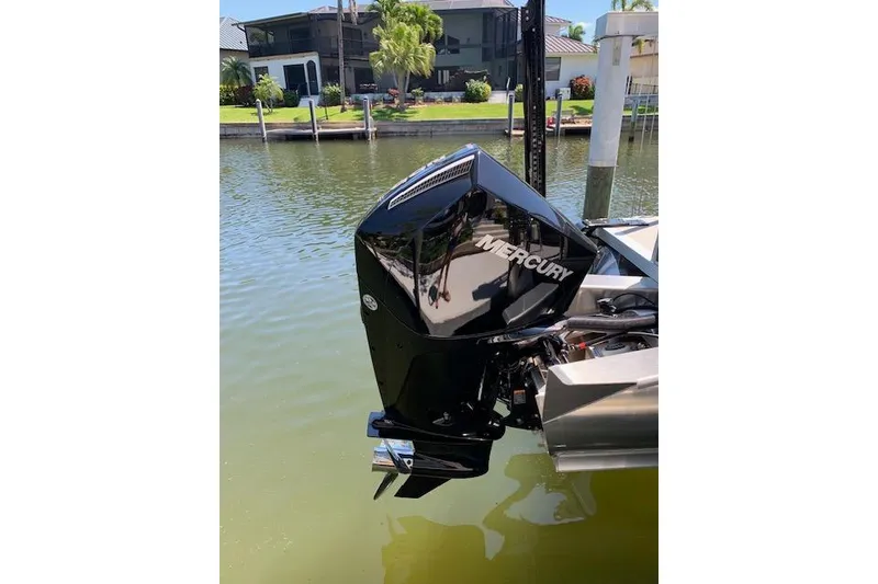 Slide: The Image of 2025 Avalon 2585 Venture QL Tri-Toon with Mercury outboard motor on a sunny waterfront. - 8
