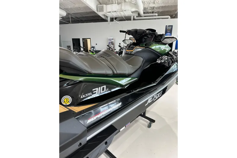 Slide: The Image of 2025 Kawasaki JV1500ASFNN Jet Ski in showroom, featuring Ultra 310LX model. - 2