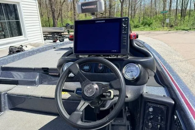 Slide: The Image of 2022 Phoenix 721 ProXP boat dashboard with steering wheel and Lowrance display. - 5