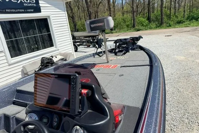 Slide: The Image of 2022 Phoenix 721 ProXP boat with advanced navigation system, parked near a building. - 6