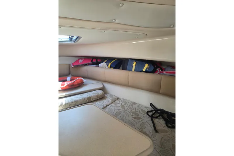 Slide: The Image of 2008 Robalo R265 Walkaround cabin interior with cushions and storage space. - 10