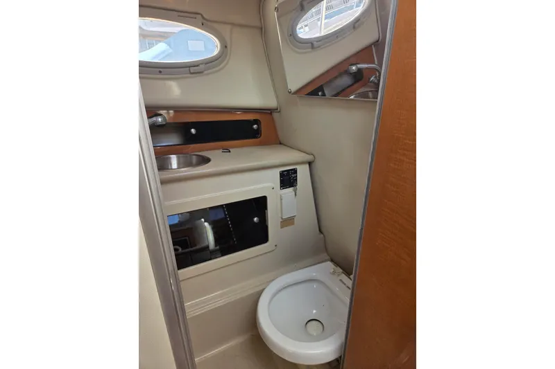 Slide: The Image of 2008 Robalo R265 Walkaround boat interior with sink and toilet. - 11