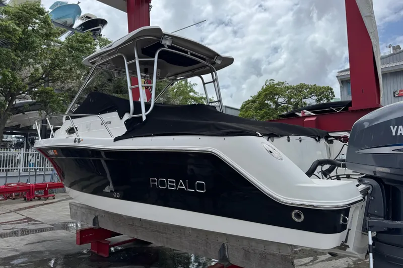 Slide: The Image of 2008 Robalo R265 Walkaround boat on display, featuring sleek design and Yamaha engine. - 2