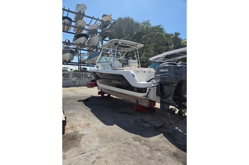 Slide: The Image of 2008 Robalo R265 Walkaround boat with Yamaha engines on a sunny day. - 4