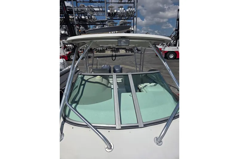 Slide: The Image of 2008 Robalo R265 Walkaround boat with windshield and T-top under a blue sky. - 5