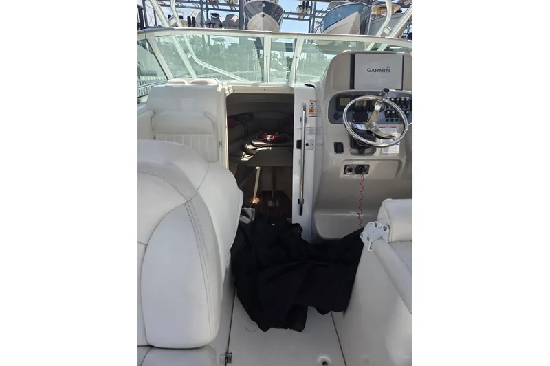 Slide: The Image of 2008 Robalo R265 Walkaround boat interior with steering wheel and seating. - 6