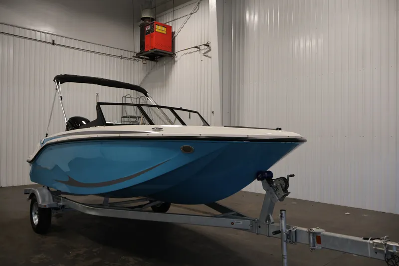 Slide: The Image of 2026 Bayliner Element M17 boat in indoor storage on trailer. - 2